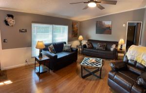 a living room with couches and a couch and a table at Bear Doodle 2.0 in Sevierville