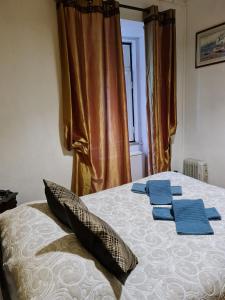 a bedroom with a bed with blue towels on it at Pensao Residencial Flor dos Cavaleiros in Lisbon