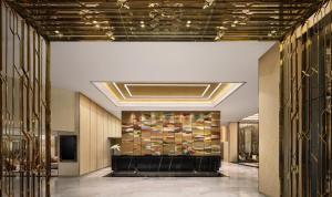 a lobby with a large wall of books at Chatrium Grand Bangkok in Bangkok