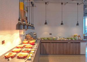 a kitchen with many food items on a counter at Holiday Inn Sunderland - City Centre, an IHG Hotel in Sunderland