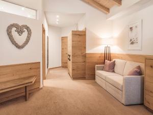 a living room with a couch and a table at Hotel Magdalena Mayrhofen in Mayrhofen