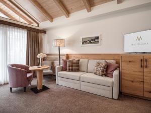 a living room with a couch and a table at Hotel Magdalena Mayrhofen in Mayrhofen