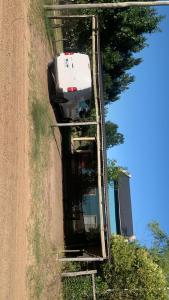 a white car parked on the side of a dirt road at Los manzanos . in Colón