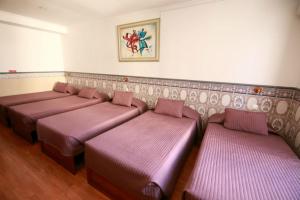 a row of benches in a room with pink seats at Residencial Joao XXI in Lisbon