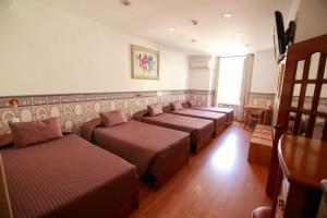 a waiting room with a row of brown benches at Residencial Joao XXI in Lisbon