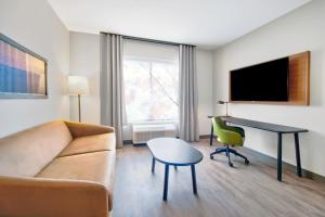 a living room with a couch and a desk at Fairfield by Marriott Inn & Suites Cincinnati North West Chester in West Chester