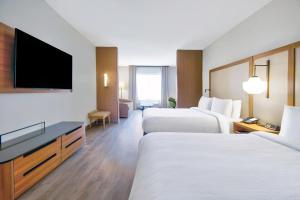 a hotel room with two beds and a flat screen tv at Fairfield by Marriott Inn & Suites Cincinnati North West Chester in West Chester