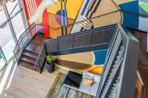 an overhead view of a staircase with a mural at Hyatt Place Gainesville Downtown in Gainesville