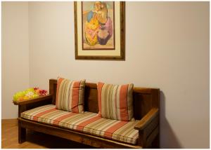 a couch sitting under a painting on a wall at Luengo House in León