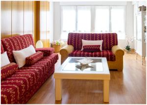 a living room with two couches and a coffee table at Luengo House in León