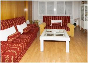 a living room with two couches and a coffee table at Luengo House in León