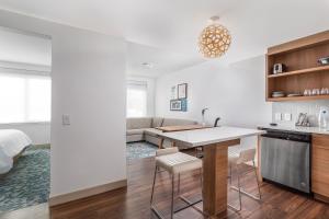 a kitchen and living room with a table and chairs at Element Knoxville West in Knoxville