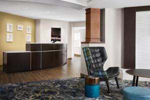 a living room with a chair and a table at Residence Inn by Marriott Harrisburg Carlisle in Carlisle