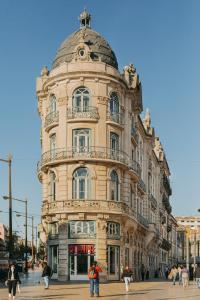 un gran edificio con una cúpula encima en 1908 Lisboa Hotel, en Lisboa