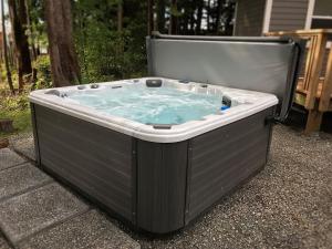 a hot tub sitting on the side of a yard at The Francis Boutique Inn in Ucluelet