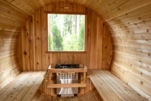 a room in a wooden cabin with a window at The Francis Boutique Inn in Ucluelet