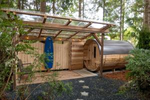 a gazebo with a surfboard under a roof at The Francis Boutique Inn in Ucluelet