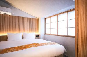 Cama ou camas em um quarto em Miru Kyoto Gion