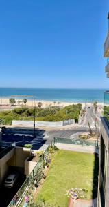 a view of the beach from a balcony of a building at Mediterranean Sea View in Ashqelon