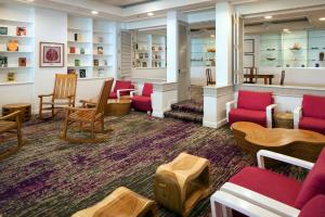 a waiting room with red chairs and tables at Sheraton Princess Kaiulani in Honolulu