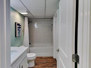 a bathroom with a tub and a toilet and a sink at Edgewater Villa 2406 in Panama City Beach