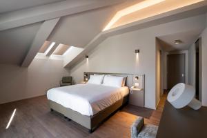 a bedroom with a large bed in a attic at Hotel Promessi Sposi in Malgrate