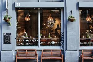 two benches sitting in front of a store window at Montcalm East, Autograph Collection in London