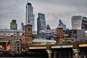 a city skyline with a train on a bridge at Montcalm East, Autograph Collection in London