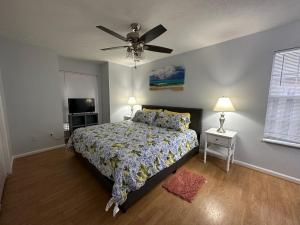 a bedroom with a bed and a ceiling fan at Beautiful House Sleeps 12 - Hot Tub - Breakfast - Walk to Beach in Panama City Beach