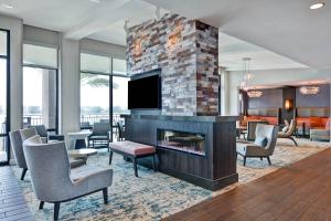 a living room with a fireplace and a tv at Residence Inn by Marriott Fort Walton Beach in Fort Walton Beach