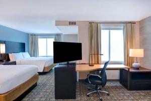 a hotel room with two beds and a desk with a computer at Residence Inn by Marriott Fort Walton Beach in Fort Walton Beach