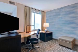 a hotel room with a desk and a television at Residence Inn by Marriott Fort Walton Beach in Fort Walton Beach