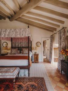 a bedroom with a bed with a canopy at Grand Hotel Son Net in Puigpunyent