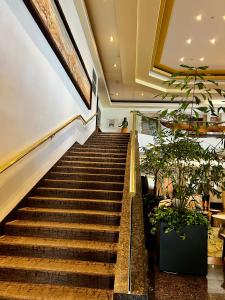 a set of stairs in a building with potted plants at Luana Waikiki Park Views in Honolulu