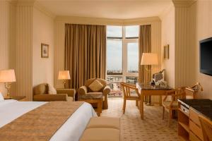 a hotel room with a bed and a desk at Sheraton Kuwait, a Luxury Collection Hotel, Kuwait City in Kuwait