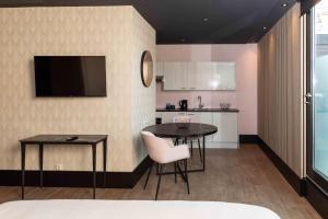 a kitchen with a table and two chairs in a room at Hotel2Stay in Amsterdam