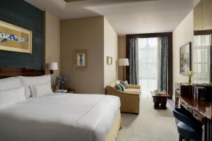 a hotel room with a bed and a living room at The Beaumont Mayfair in London