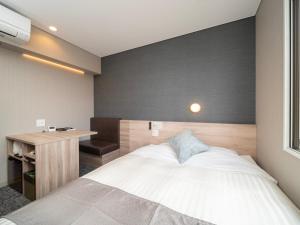 Krevet ili kreveti u jedinici u okviru objekta Super Hotel Premier Sendai Kokubuncho Tennenonsen