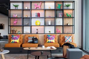 a living room with a couch and a shelf of furniture at Moxy Rust in Rust