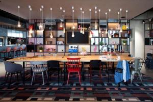 a dining room with a large table and chairs at Moxy Rust in Rust