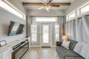 a living room with a couch and a tv at Community Pool and Hot Tub Austin Tiny Home! in Austin