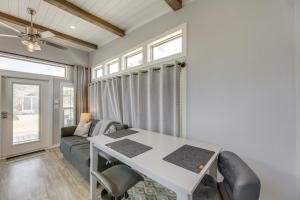 a living room with a table and a couch at Community Pool and Hot Tub Austin Tiny Home! in Austin