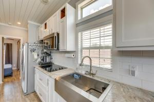 a kitchen with a sink and a refrigerator at Community Pool and Hot Tub Austin Tiny Home! in Austin