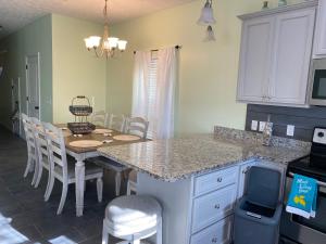 a kitchen with a table and a kitchen with a dining room at The Pelican’s Nest in Panama City Beach