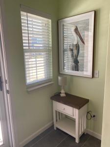 a room with a table and a picture of a pelican at The Pelican’s Nest in Panama City Beach