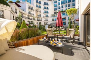 a patio with tables and chairs and a building at CVK Park Bosphorus Hotel Istanbul in Istanbul