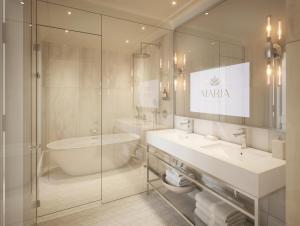 a bathroom with a tub and a sink and a toilet at The Hotel Maria - Preferred Hotels & Resorts in Helsinki