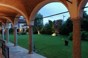 a view of a yard from the porch of a house at Hotel Il Chiostro by LVG Hotel Collection in Verbania