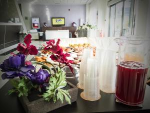 a counter with vases and flowers on a table at Best Western Hotel Class Lamezia in Lamezia Terme