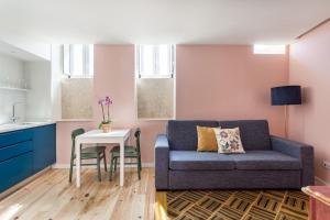 a living room with a couch and a table at JOIVY Flats next to Rossio Square and main Lisbon attractions in Lisbon